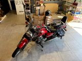 a red motorcycle that is parked in a garage