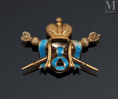 a close up of a gold and blue broochle on a black background