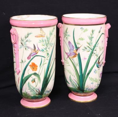 two vases sitting side by side on a black background