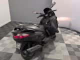 a motor scooter that is parked on a checkered floor