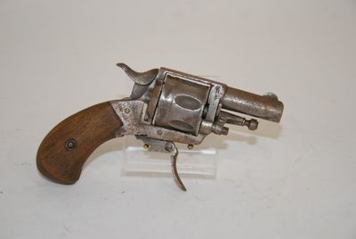 an old revolver with a wooden handle on a white surface