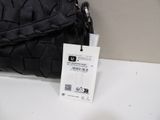 a black purse with a price tag attached to it