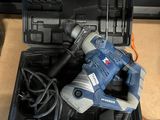 an image of a corded drill in a tool case on a table