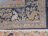 a close up of a rug with a bird design on it