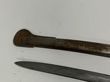 two different types of knives on a white surface