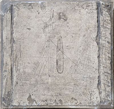 a stone plaque with a boat on it on a wall