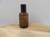 an image of a bottle of perfume on a wooden table