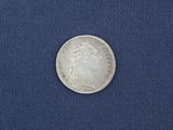 a close up of a silver coin on a blue cloth