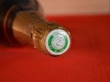 a close up of a bottle of beer on a red table