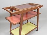 an image of a wooden and glass serving cart on wheels