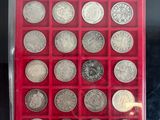 a display case with a lot of silver coins in it