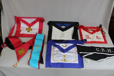 many masonic aprons laid out on a table
