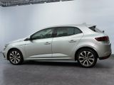 the rear end of a silver car in a white room