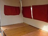 an image of a bed in a room with red curtains