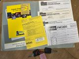 a lot of documents and a car key on the table