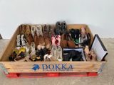 many pairs of shoes in a wooden box on the floor