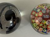 two glass objects sitting on a table next to each other