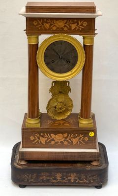 a clock that is sitting on top of a wooden stand