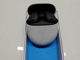 a white box with a pair of black earphones in it