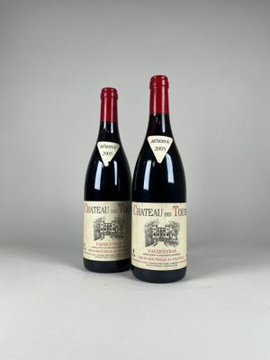 two bottles of red wine sitting next to each other on a table