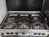 a stove with a black top in a small kitchen