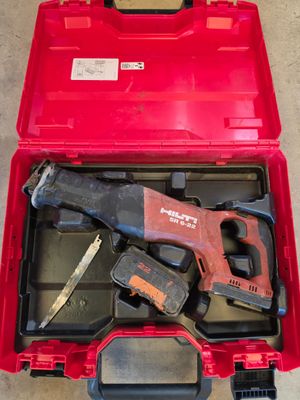 a red tool box with tools in it on the floor