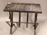 a close up of a table with a stone top and metal legs