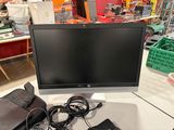 a computer monitor sitting on top of a white desk