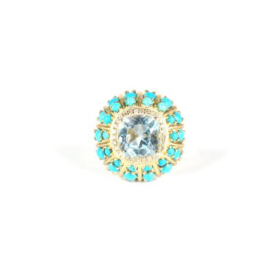 un gros plan d'une bague ornée de pierres bleues