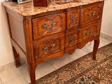 a dresser with a marble top in a room