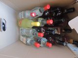 many bottles of alcohol in a box on the table