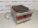 a close up of an electric grill on a counter top