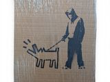 a picture of a man with a chainsaw on a cardboard box