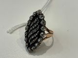 a close up of a black and white diamond ring on a white surface