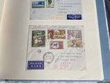 an open book with stamps on it sitting on a table