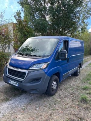 the blue van is parked on the side of the road