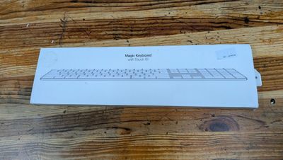 a white box with a keyboard on a wooden table