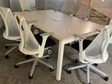 tables and chairs in a conference room with a glass wall