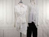 two mannequins dressed in white shirts and black pants