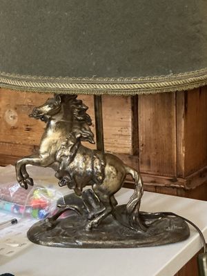 a lamp that has a horse on it on a table