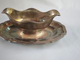 an image of a silver cup and saucer on a white table