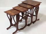 three wooden nesting tables with intricate designs on them