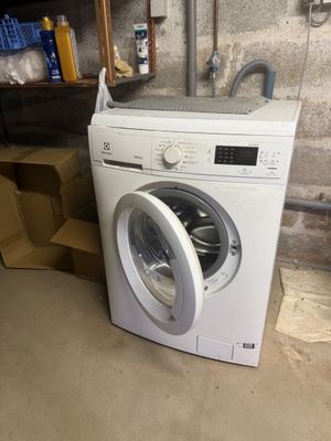 a washing machine that is sitting in a garage