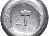 an old silver coin with a cross on it on a white background