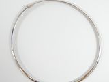 a close up of a silver necklace on a white surface