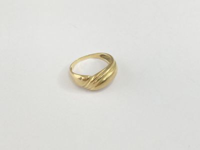 a close up of a gold ring on a white surface