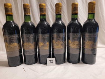 six bottles of wine are lined up in a row on a table