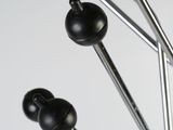 a close up of a metal object with black balls on it