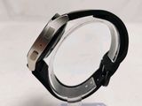 a close up of a watch on a clear stand
