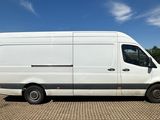 the white van is parked on the side of the road